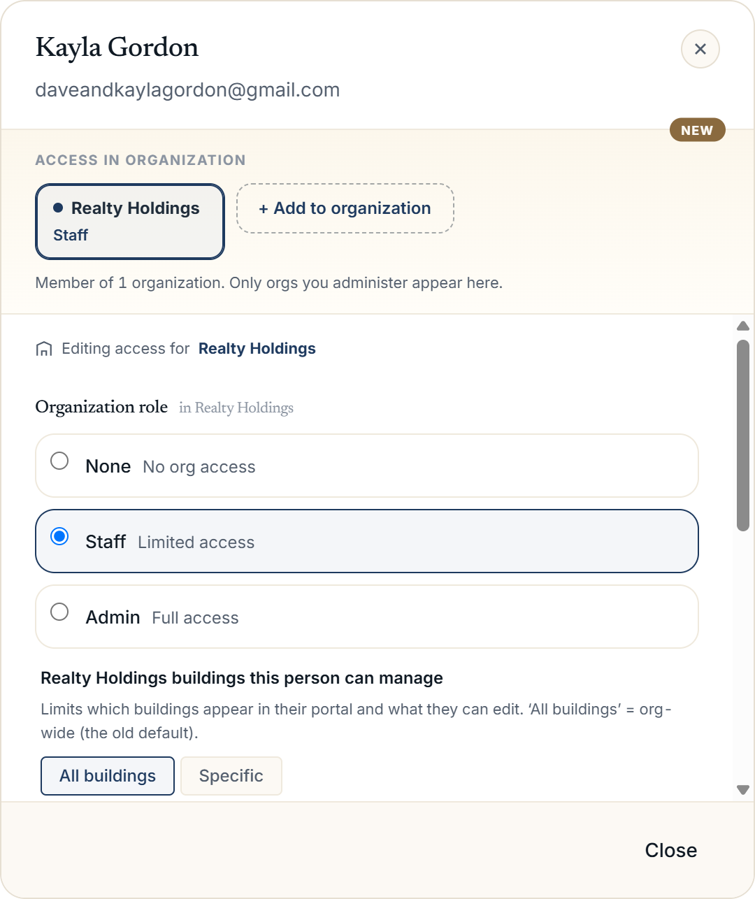 The Manage access modal open on a person, showing the Organization role radio options and the buildings-they-can-manage checklist